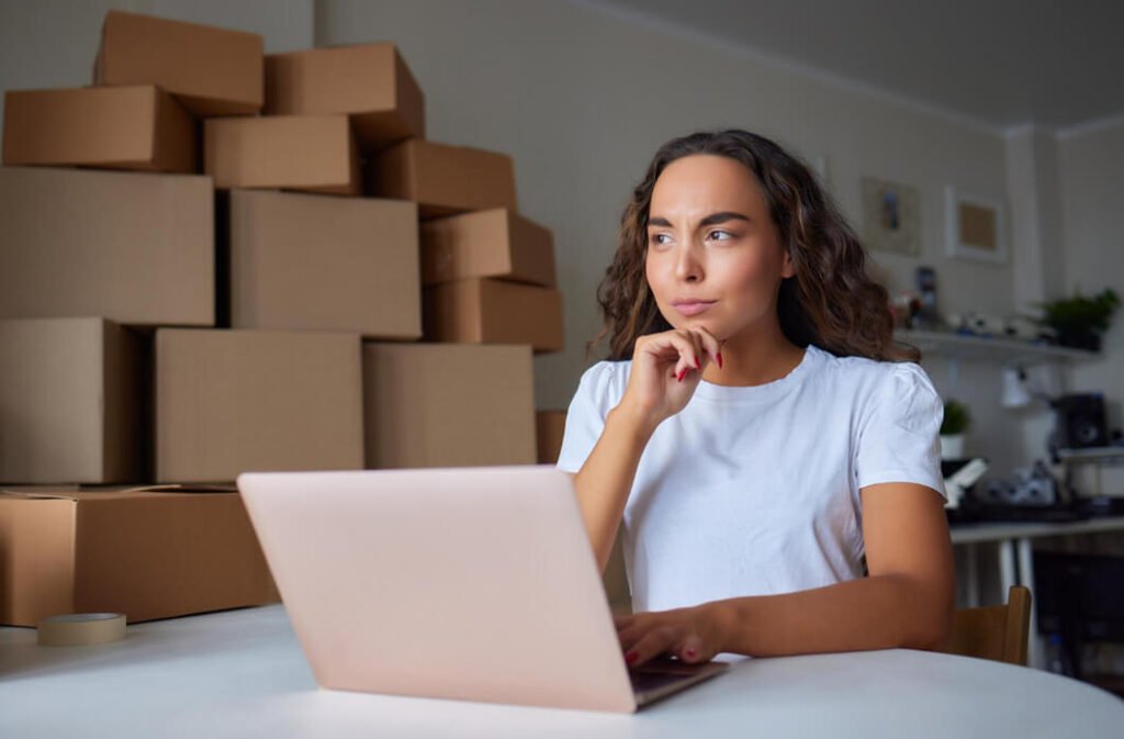 mulher-com-camiseta-branca-em-escritorio-de-comercio-eletronicocom-duvida-sobre-como-vender-online